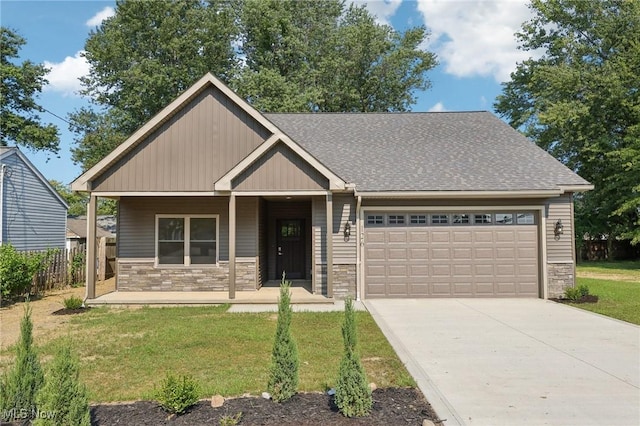 craftsman-style house with a front lawn, a porch, a garage, stone siding, and driveway