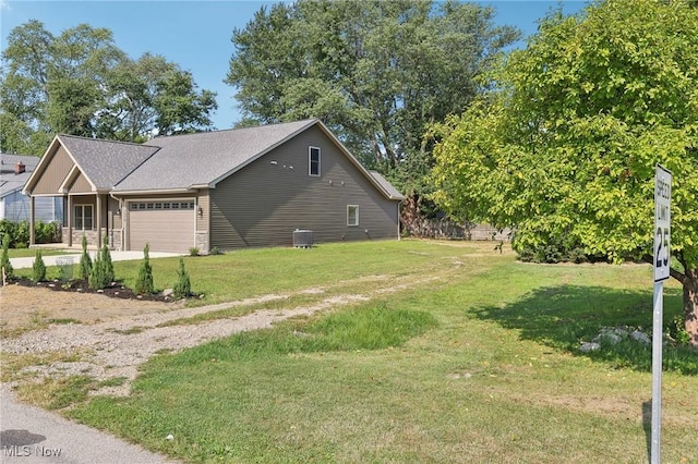 view of side of home with driveway, a lawn, a garage, and central AC