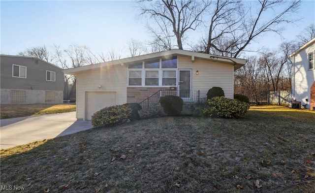 mid-century modern home with an attached garage and driveway