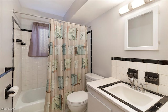 bathroom featuring backsplash, shower / bath combination with curtain, toilet, and vanity