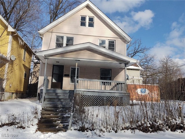 american foursquare style home with covered porch