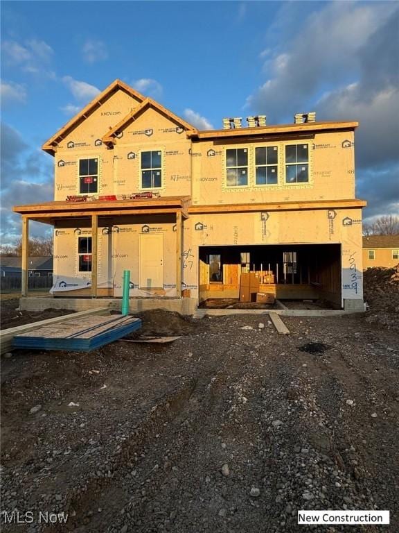 rear view of house with a garage and driveway