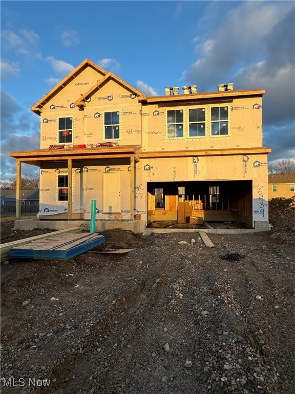 rear view of house featuring an attached garage
