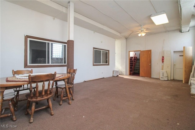 dining space with carpet and a ceiling fan