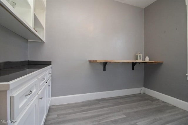 washroom featuring light wood-type flooring and baseboards