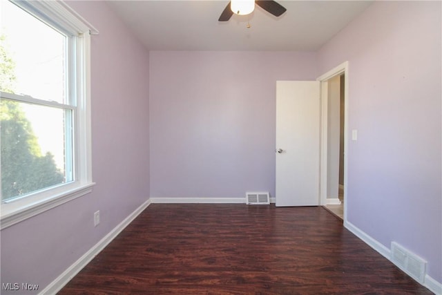 unfurnished room featuring visible vents, baseboards, ceiling fan, and wood finished floors