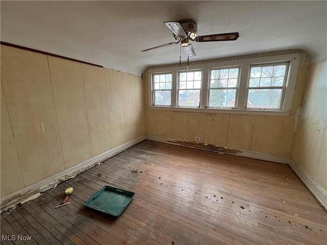 spare room with a ceiling fan and light wood finished floors