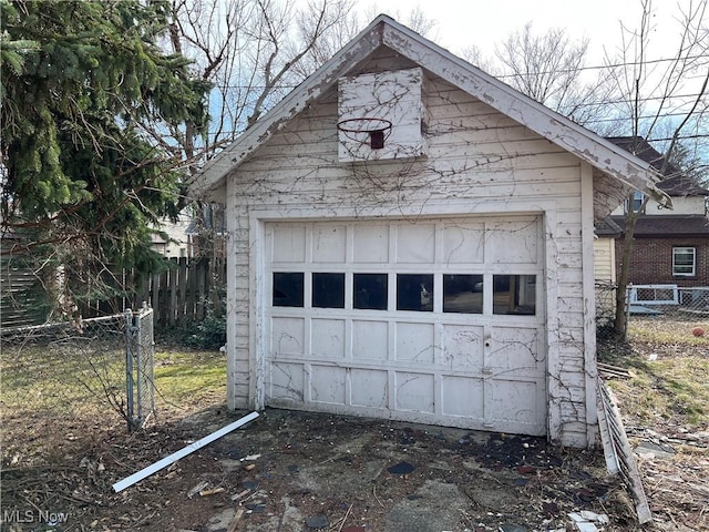 detached garage featuring fence