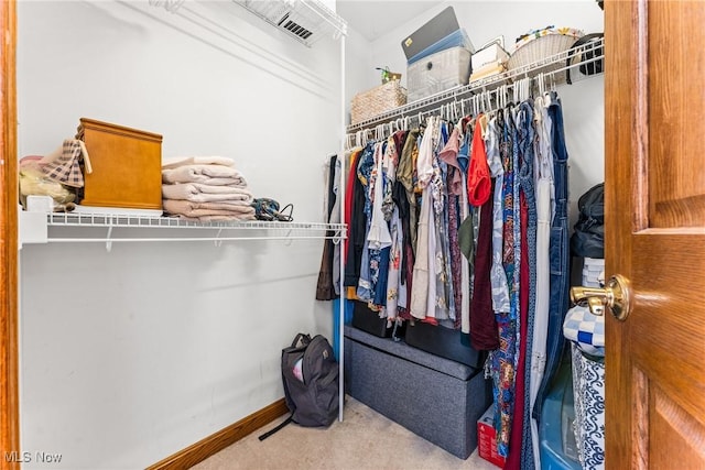 walk in closet with visible vents and carpet floors