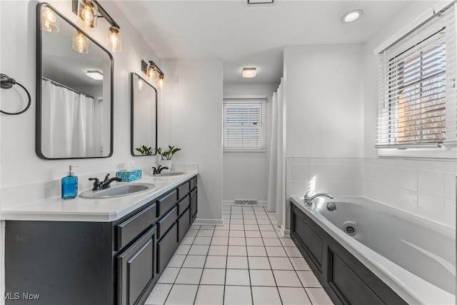 bathroom featuring a sink, a garden tub, double vanity, and tile patterned flooring