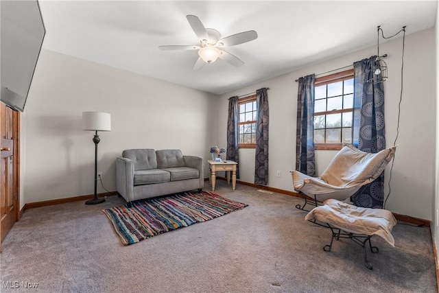 living room featuring baseboards, carpet floors, and ceiling fan