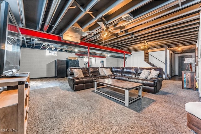 living area with stairs and a ceiling fan