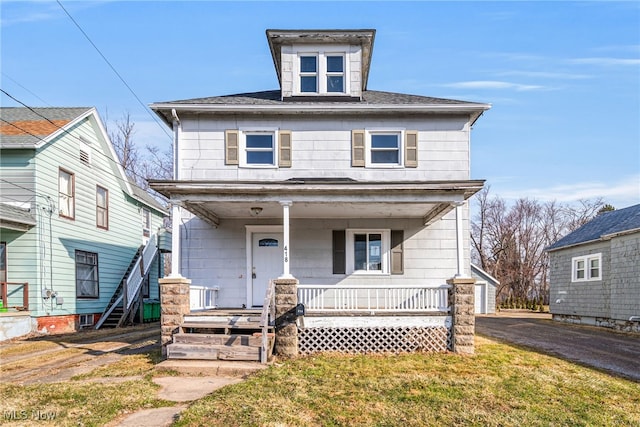 traditional style home with a porch and a front yard