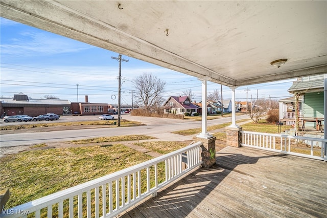 wooden deck featuring a residential view and a porch