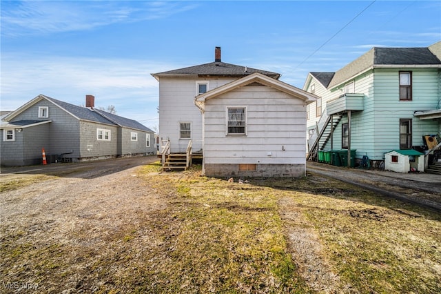 rear view of property featuring crawl space