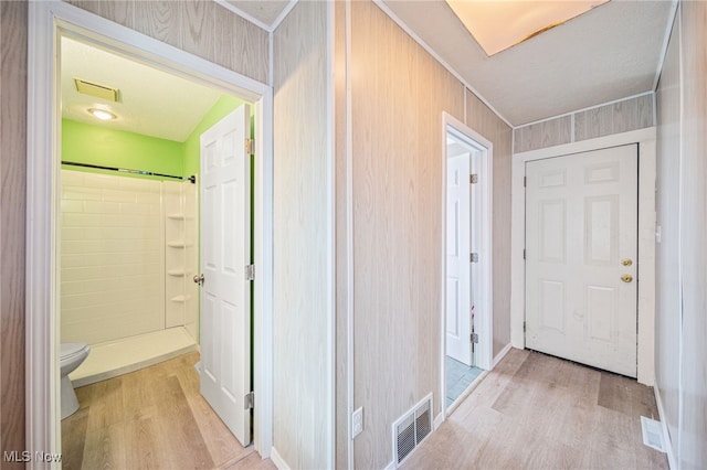 corridor with visible vents and light wood finished floors