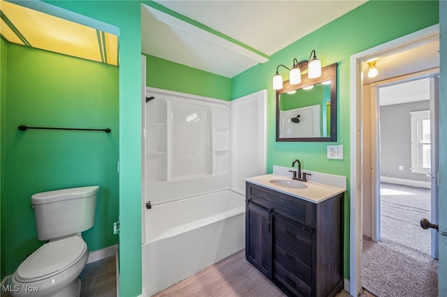 bathroom with vanity, shower / bathing tub combination, toilet, and baseboards