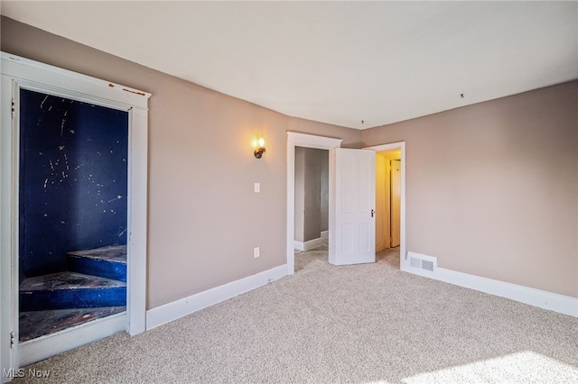 unfurnished bedroom with visible vents, baseboards, and carpet floors