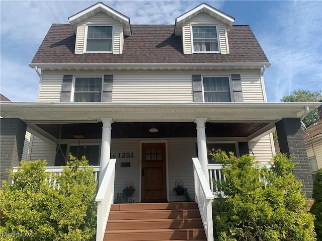 view of front of home with a porch and a shingled roof