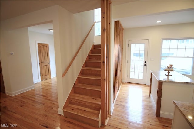 staircase featuring recessed lighting, baseboards, and wood finished floors