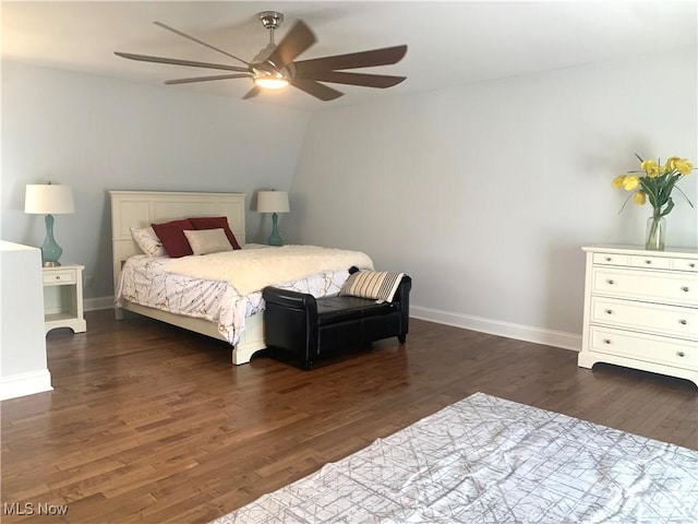 bedroom featuring dark wood-style floors, a ceiling fan, and baseboards