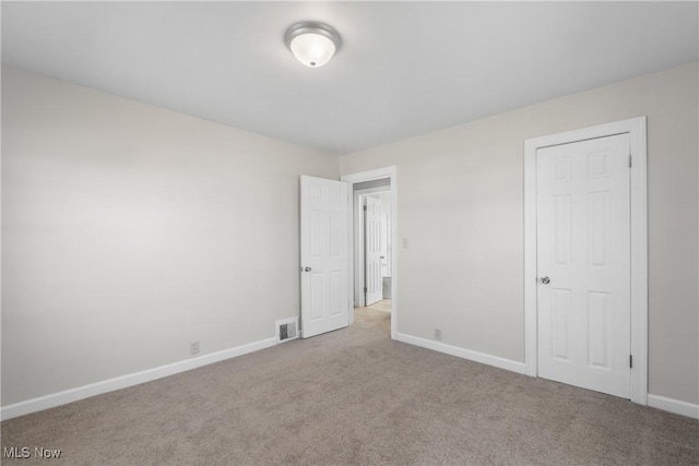 unfurnished bedroom with visible vents, baseboards, and carpet