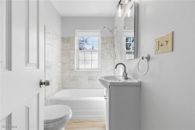 bathroom with vanity, shower / tub combination, toilet, and wood finished floors