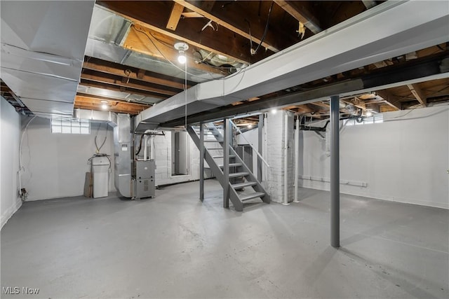 basement featuring stairway and heating unit