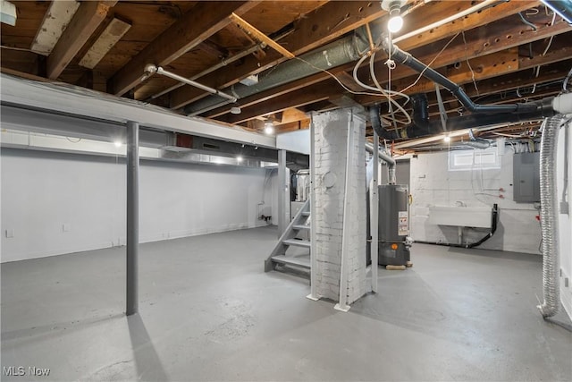 below grade area featuring gas water heater, stairway, electric panel, and a sink