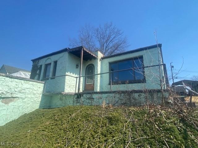 view of side of home with stucco siding