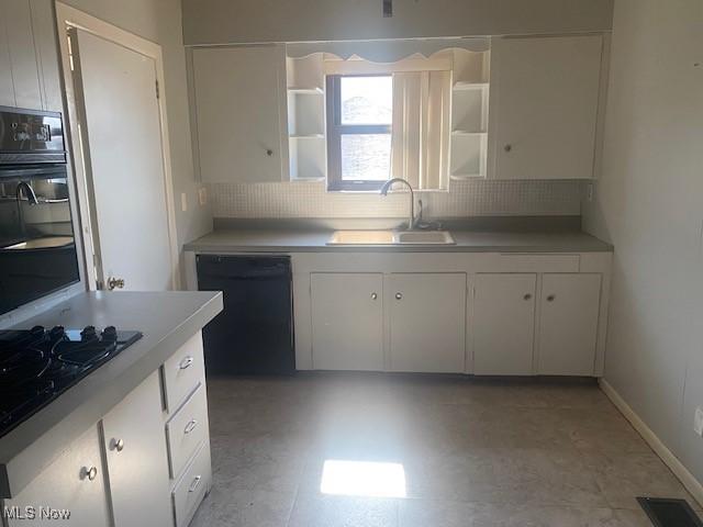 kitchen with open shelves, a sink, black appliances, light countertops, and white cabinetry