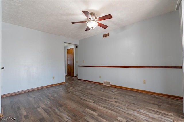 unfurnished room featuring wood finished floors, a ceiling fan, visible vents, and baseboards