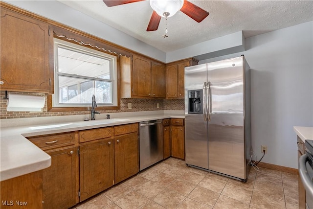 kitchen with brown cabinets, backsplash, and stainless steel appliances