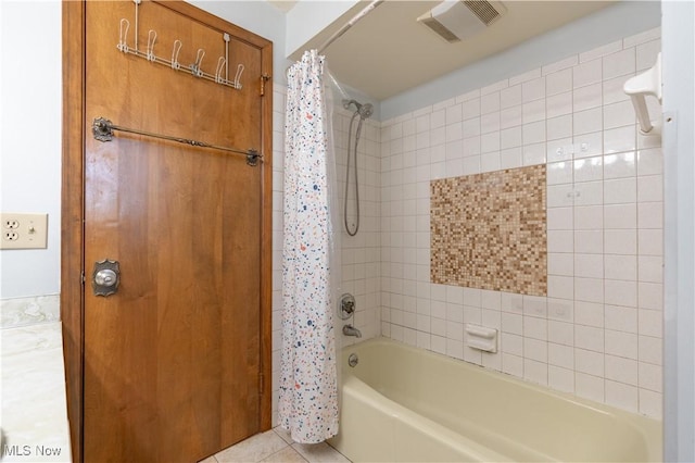 full bath featuring tile patterned floors, visible vents, and shower / tub combo with curtain