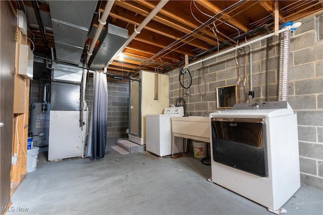 unfinished basement with heating unit, water heater, and washer and clothes dryer