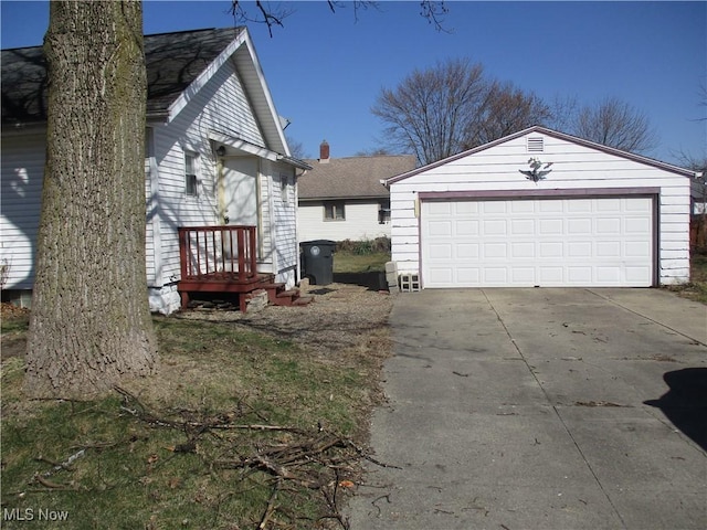 view of home's exterior featuring an outdoor structure and a garage