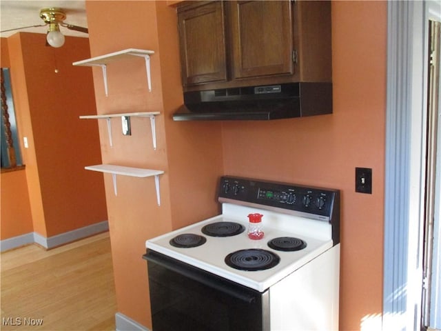 kitchen featuring baseboards, under cabinet range hood, range with electric stovetop, light wood-style floors, and open shelves