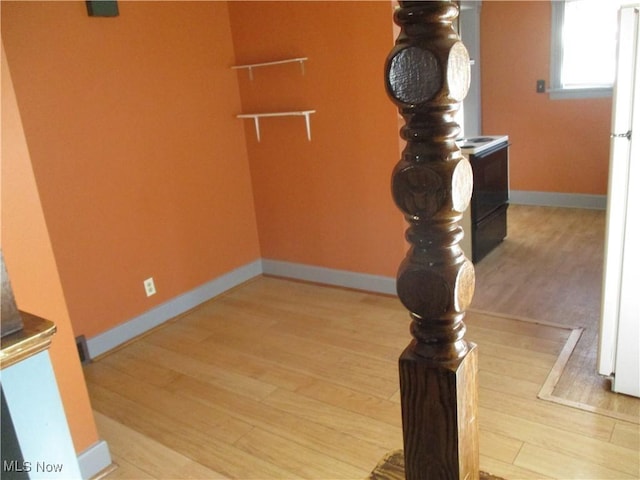 interior space with wood finished floors and baseboards