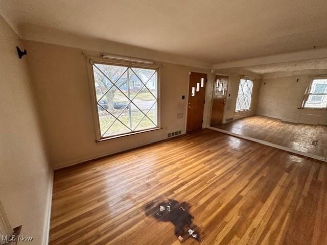 foyer featuring visible vents and wood finished floors