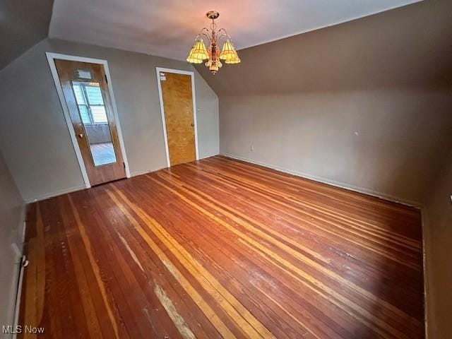 bonus room featuring a chandelier, lofted ceiling, and wood-type flooring