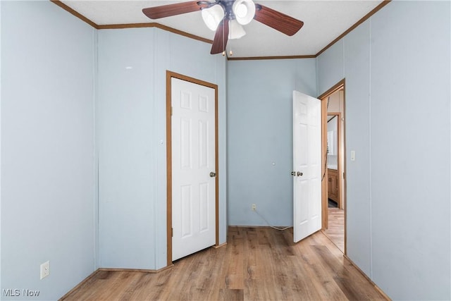 unfurnished bedroom featuring crown molding, wood finished floors, and ceiling fan