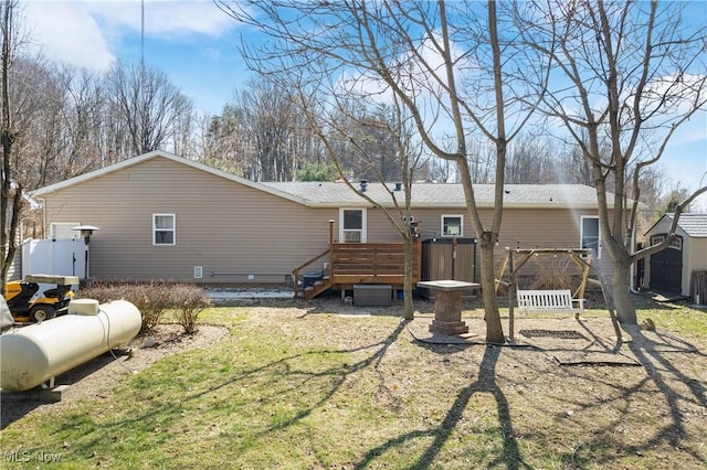 back of house with a wooden deck