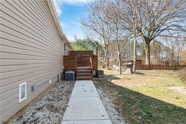 view of yard featuring cooling unit, fence, and a wooden deck