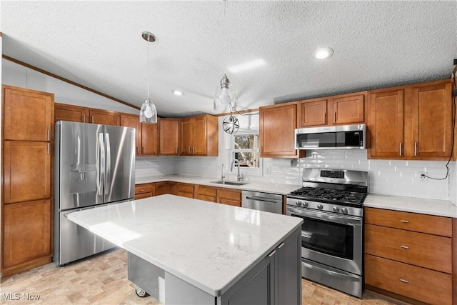 kitchen featuring brown cabinetry, a sink, stainless steel appliances, vaulted ceiling, and backsplash