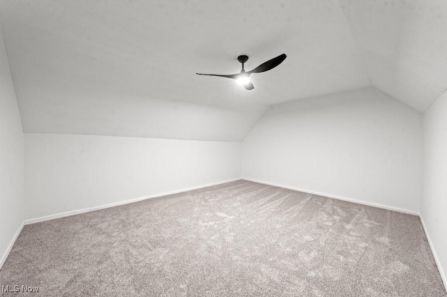 additional living space with baseboards, carpet floors, ceiling fan, and vaulted ceiling