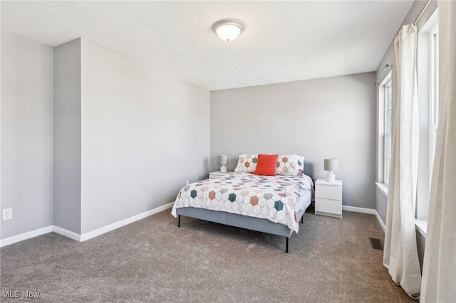 carpeted bedroom with visible vents and baseboards