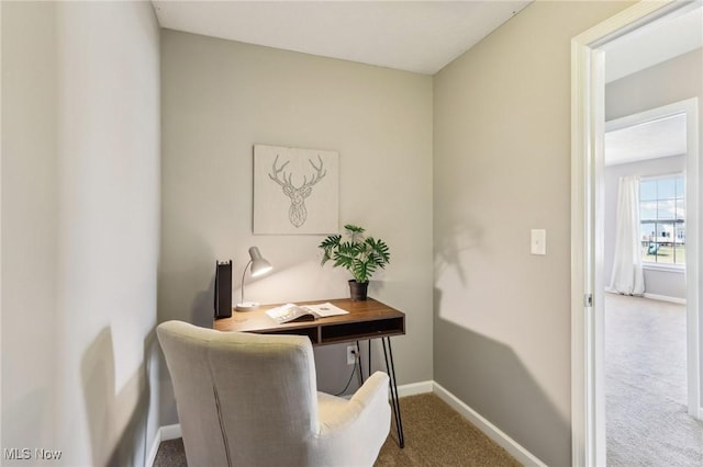 carpeted home office featuring baseboards