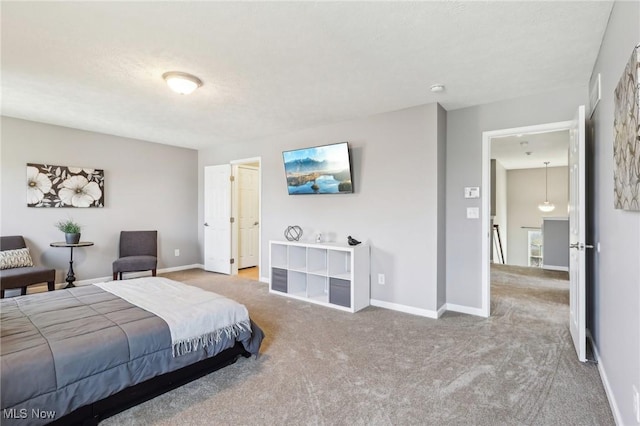 carpeted bedroom with a textured ceiling and baseboards