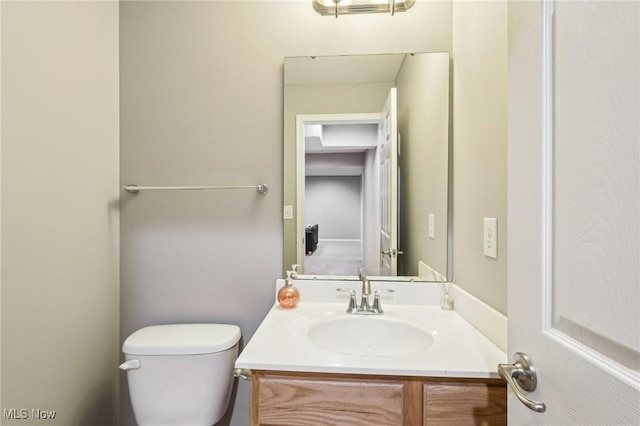 half bathroom featuring toilet and vanity