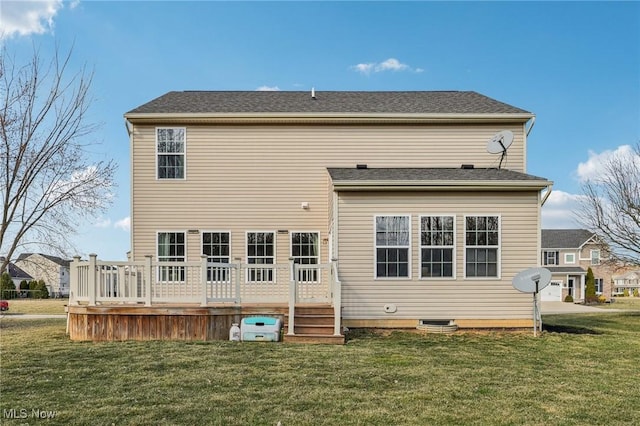 rear view of property featuring a deck and a yard